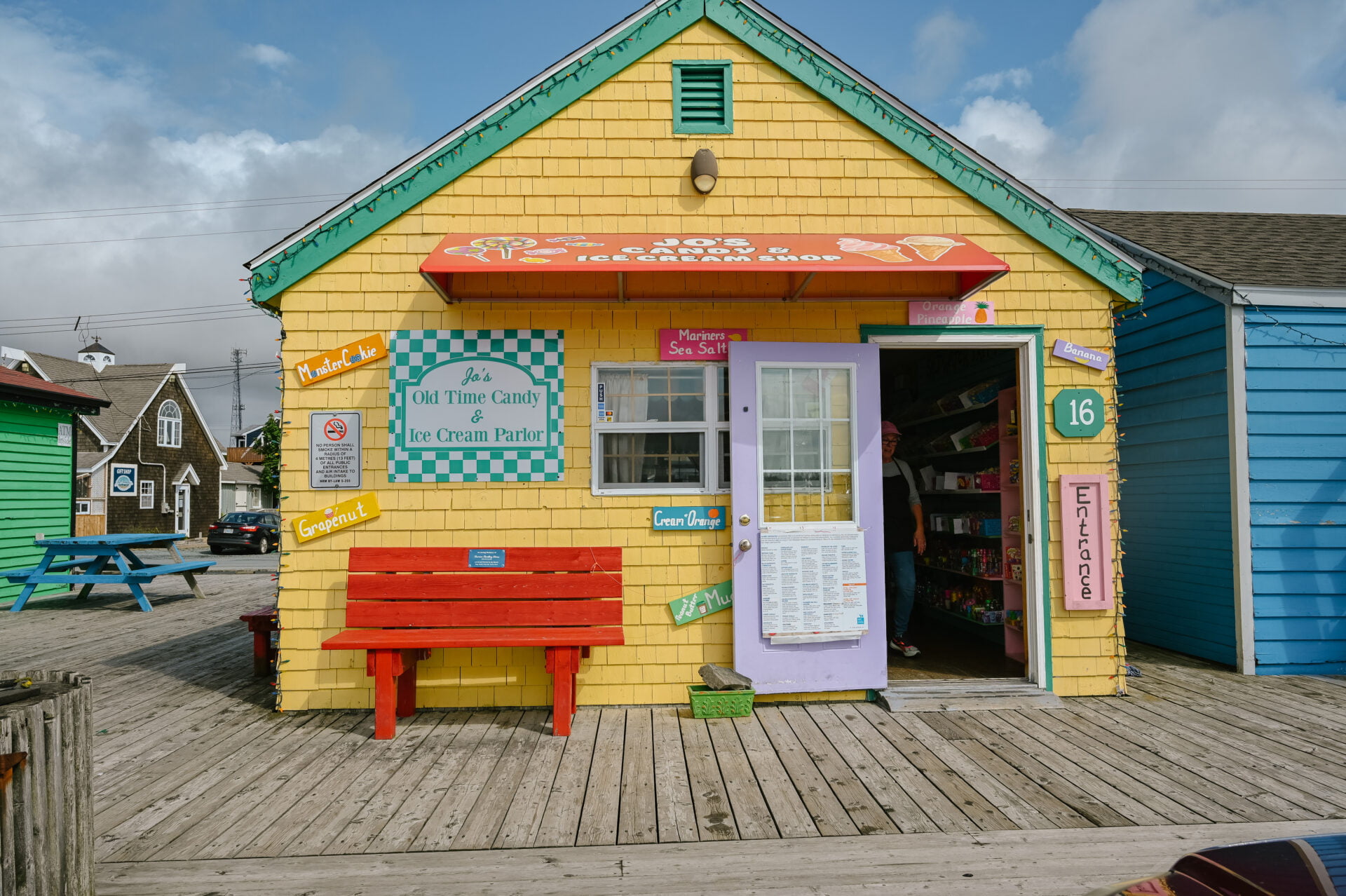 front entrance of a yellow store that is jo's candy and ice cream shop in fisherman's cove nova scotia