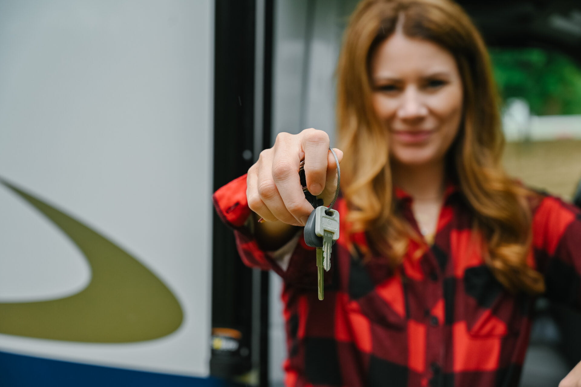 woman holding out the keys to an rv