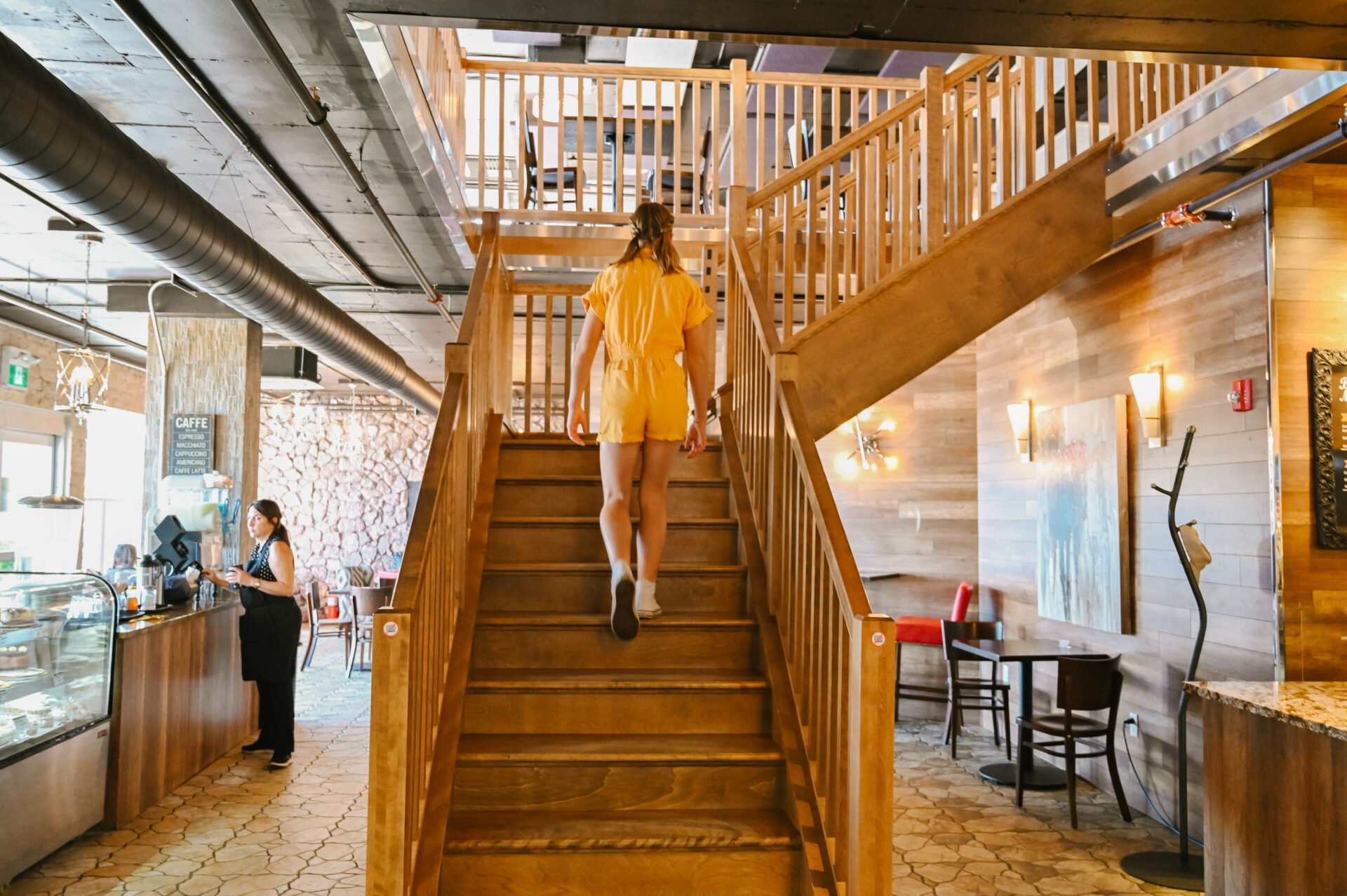 girl walking up the stairs of inside of the bedford basin farmers market cafe and bistro