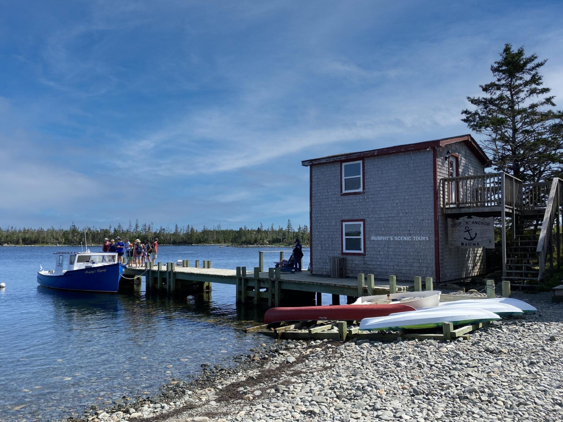 view of the building, dock and boats at murphy's scenic tours on our eastern shore road trip in nova scotia