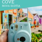 polaroid camera taking a photo of fisherman's cove nova scotia