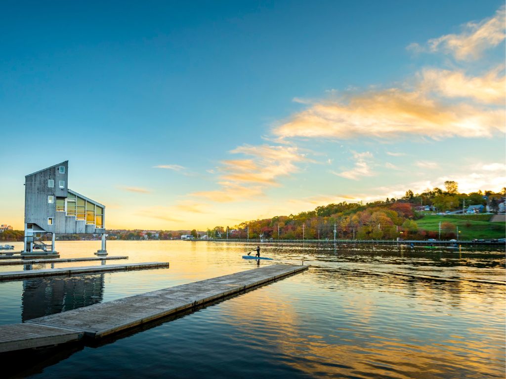 dock view with a person paddleboarding in lake banook - things to do in dartmouth nova scotia in the summer 