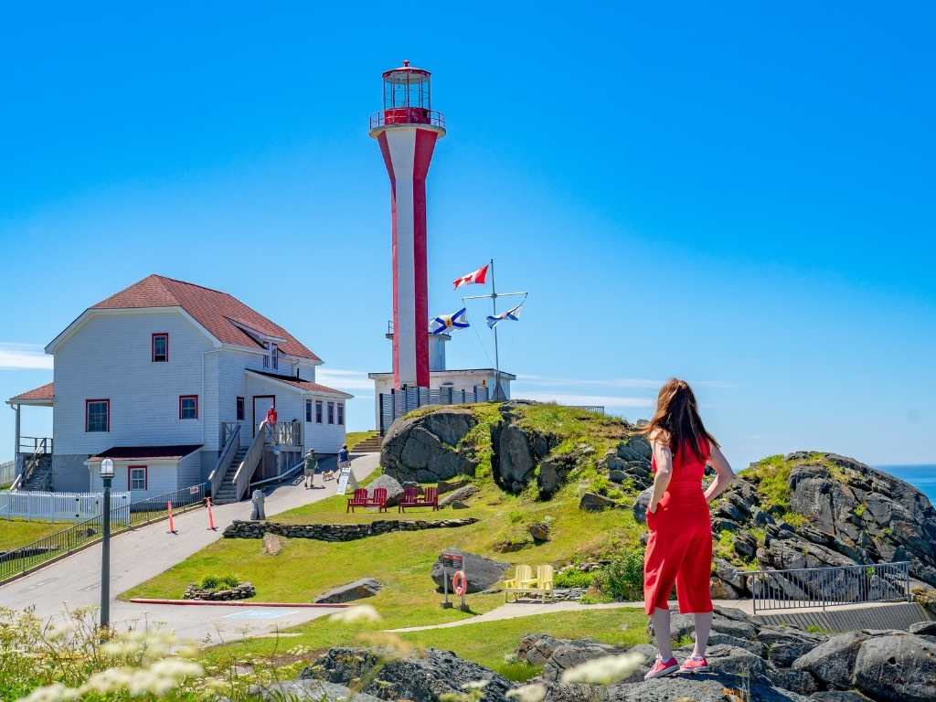 woman looking at a lighthouse in yarmouth on our Nova Scotia RV road trip