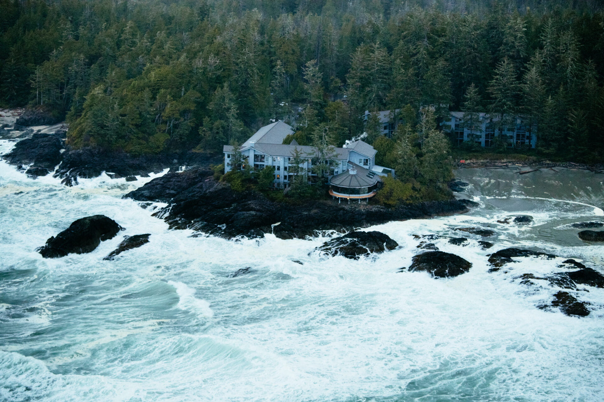birds eye view looking down at the wickanninish inn on chesterman beach, the best storm watching hotel in tofino