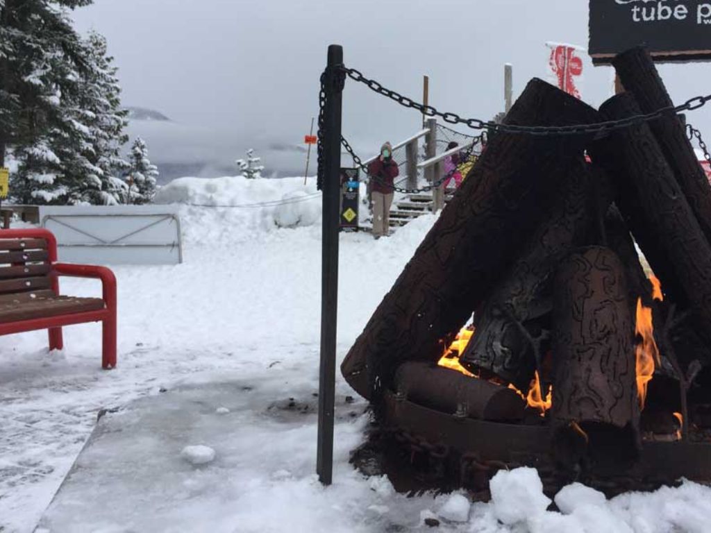 fire pit and benches where you can relax and warm up after sliding at the whistler tube park