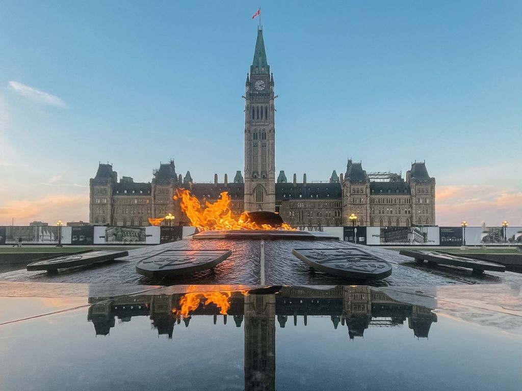 canadian parliament buiding in ottawa with flame out front