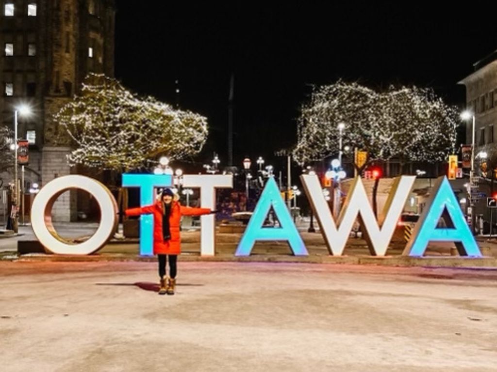 what to do in Ottawa in November - woman standing in front of the large lit up ottawa sign