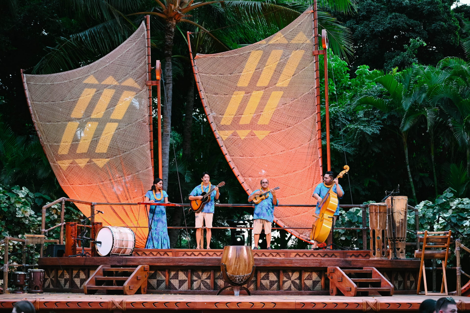 cast members performing at the luau at aulani a disney resort and spa