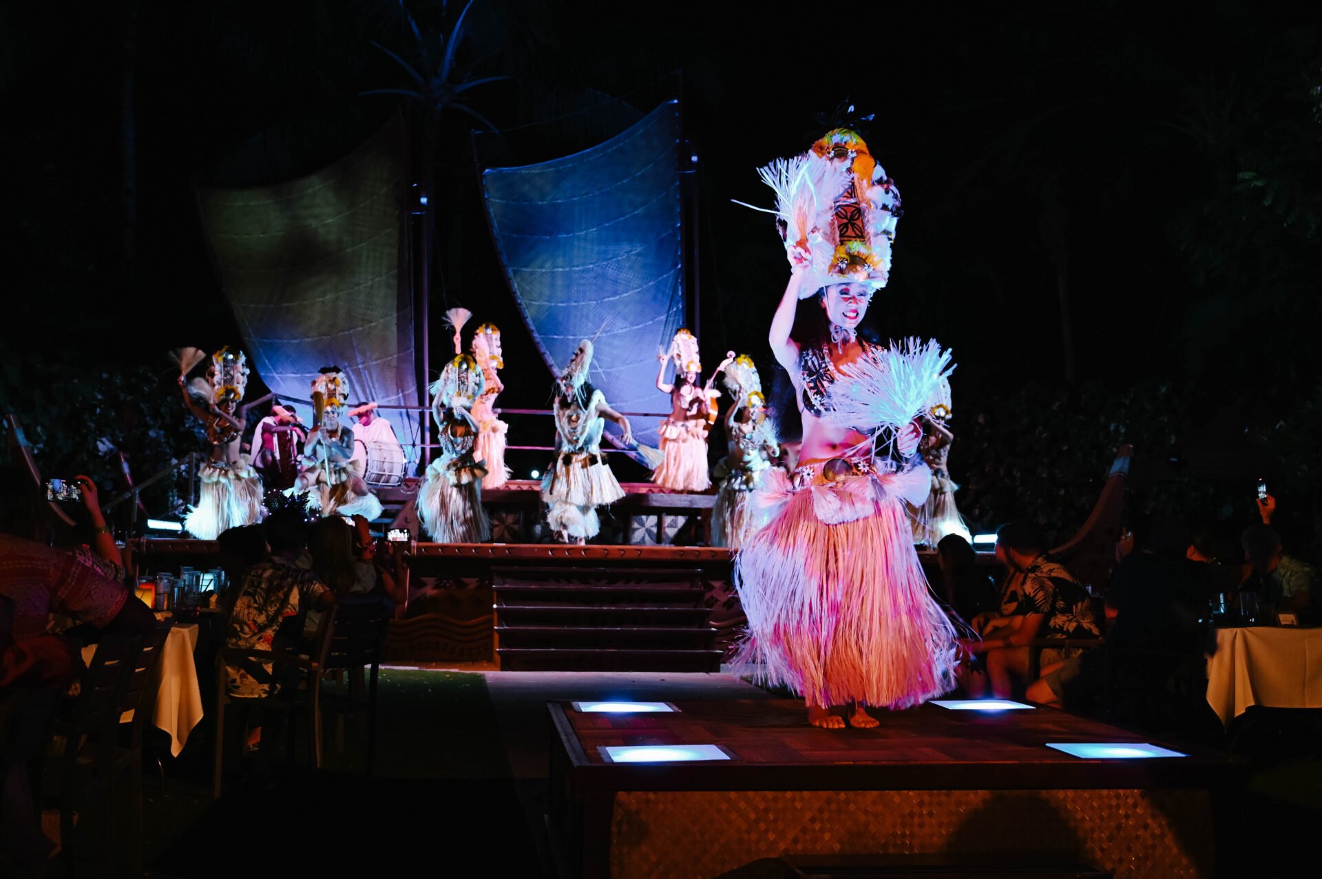 hula dancer dressed in elaborate outfit performing at the aulani a disney resort and spa luau