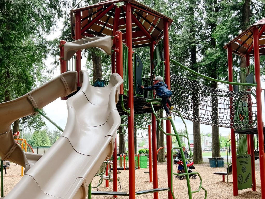 child climbing the playground at harris road park in pitt meadows