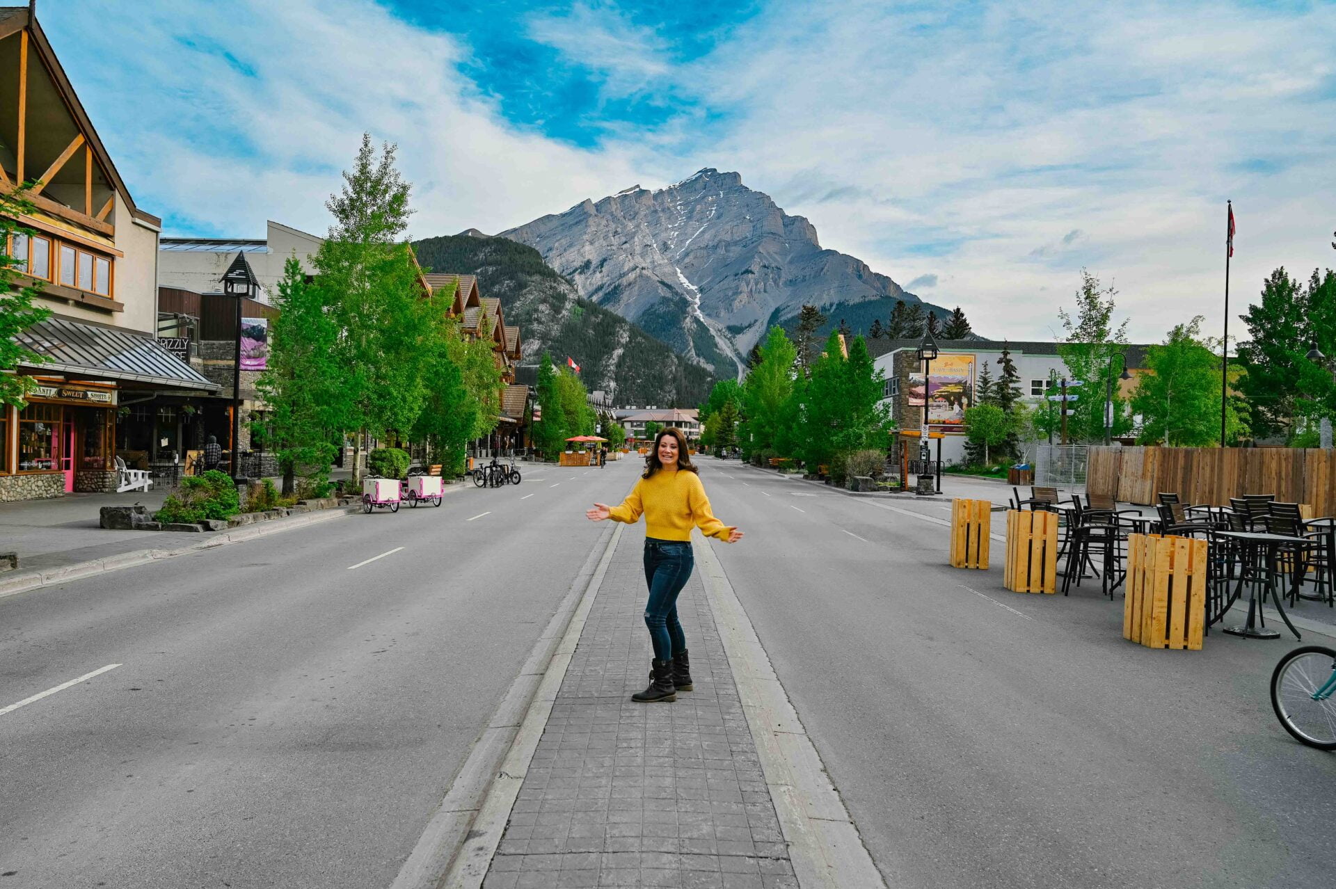 woman standing in the middle of the road in downtown banff