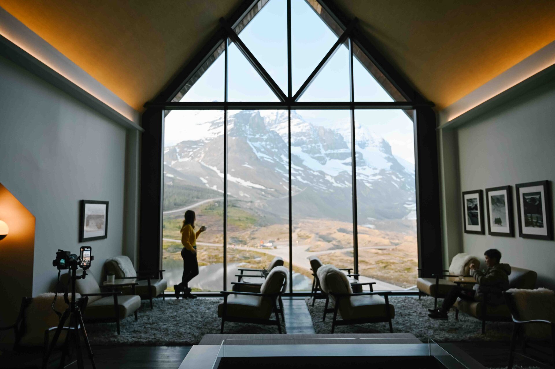 woman standing in the window looking out at the glacier at glacier view lodge review