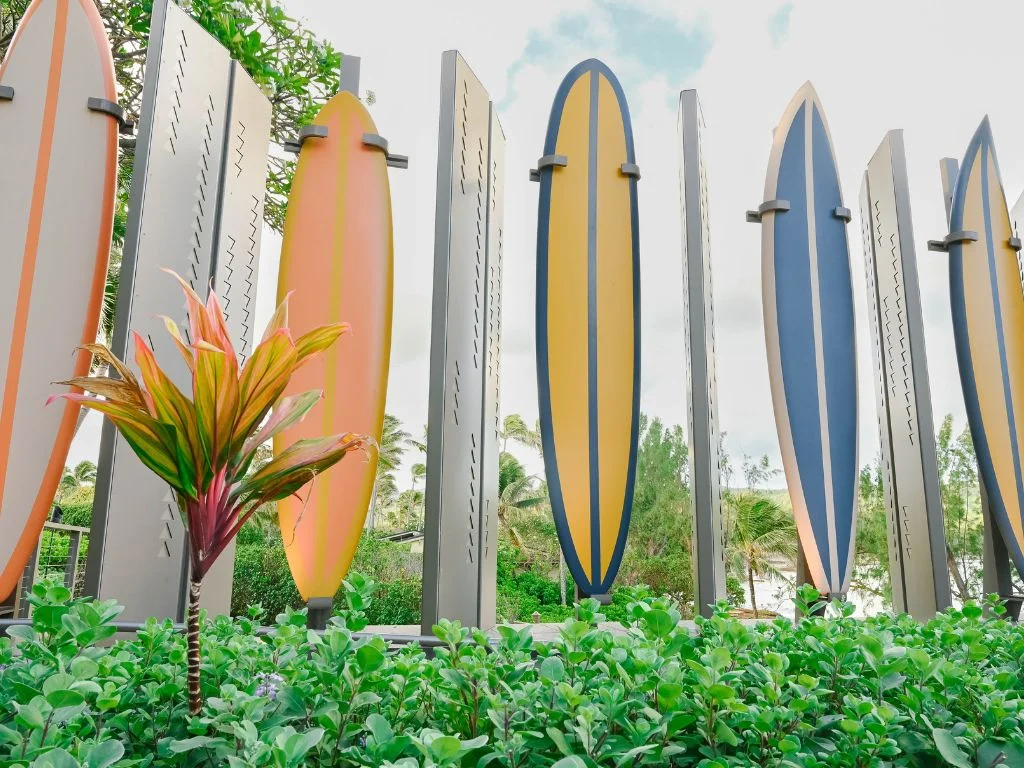 a line of surfboard art outside the entrance of turtle bay resort