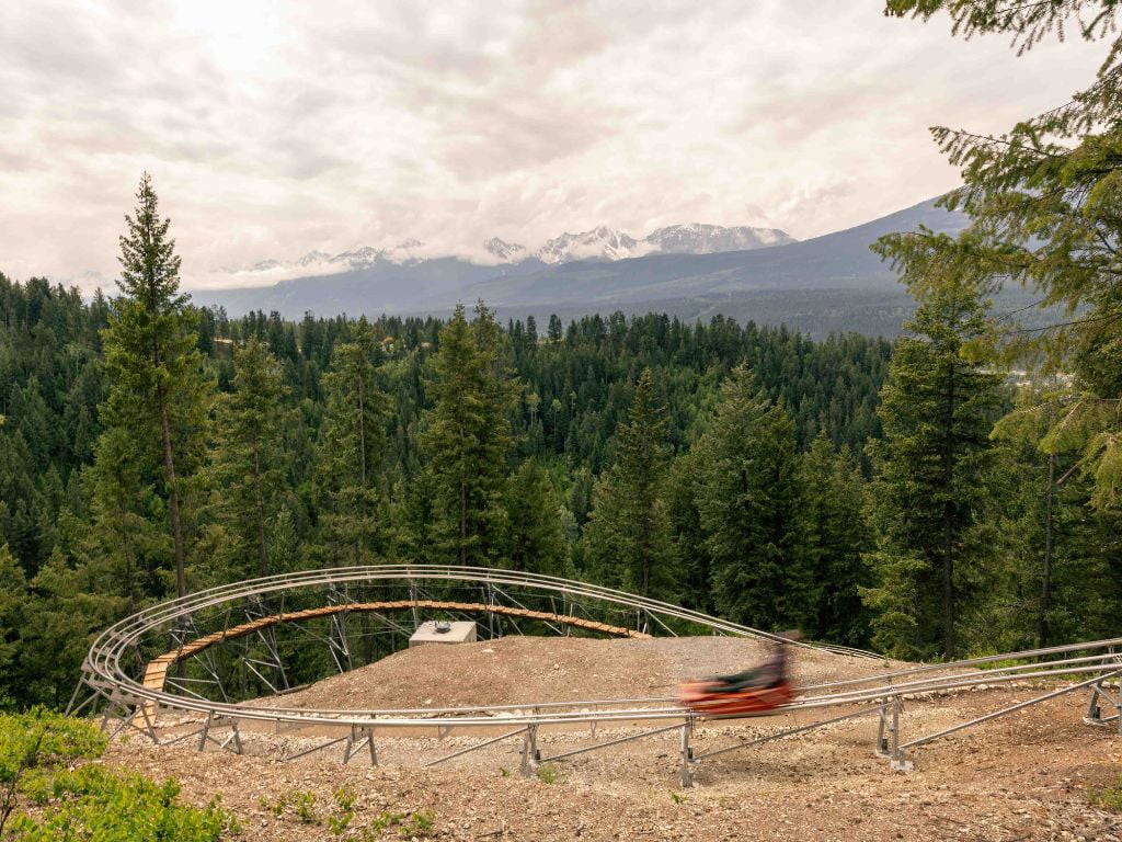 person speeding down the hill on the railrider mountain coaster at the golden skybridge