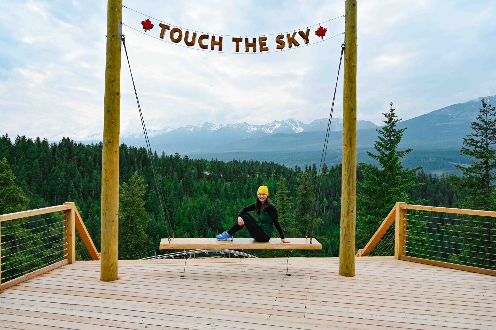 touch the sky viewpoint where a woman sits posing in front of the camera