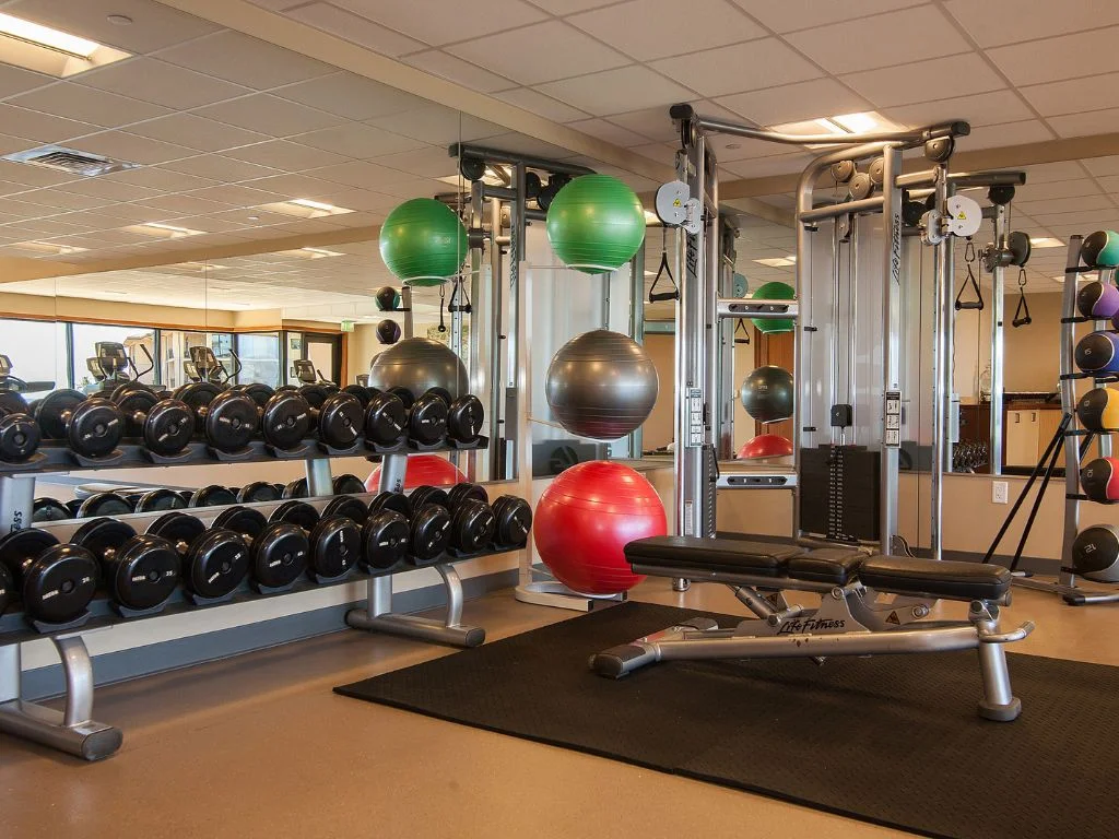 inside of the fitness centre that is filled with various weights and machines at koloa landing resort, the best family hotel in kauai