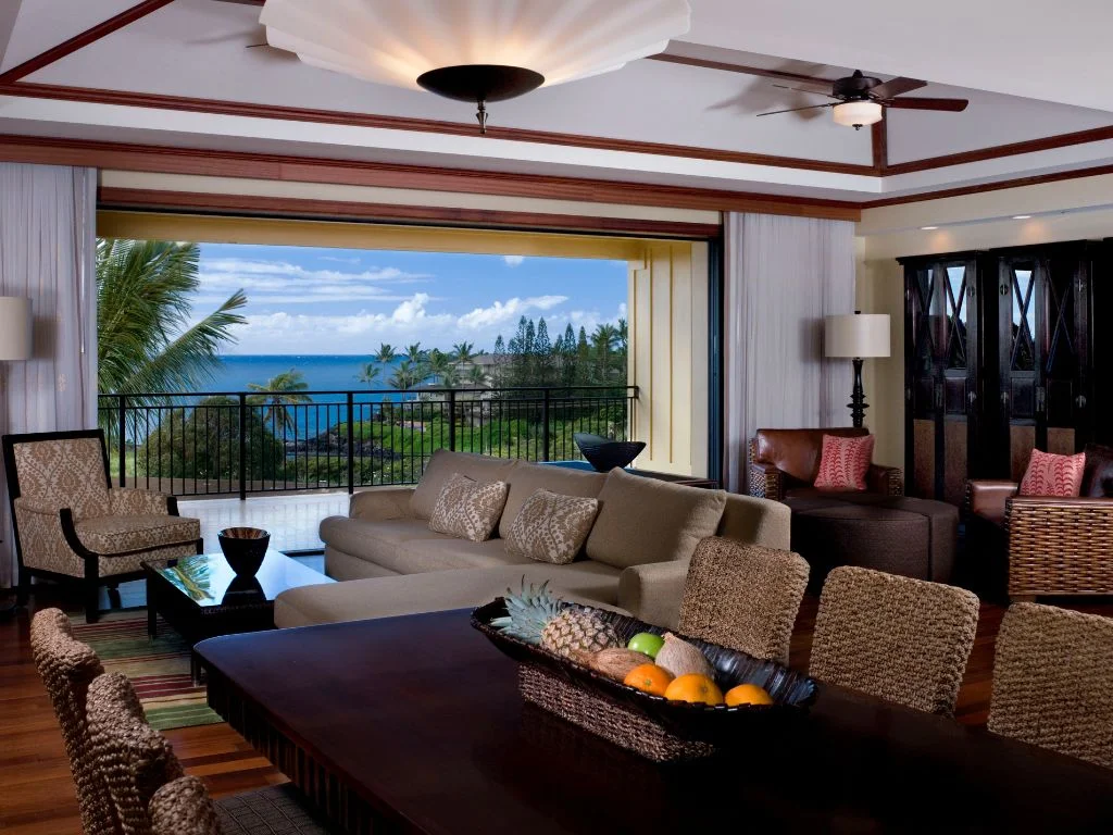 view of the living room overlooking the large lanai and gorgeous ocean view from a penthouse suite