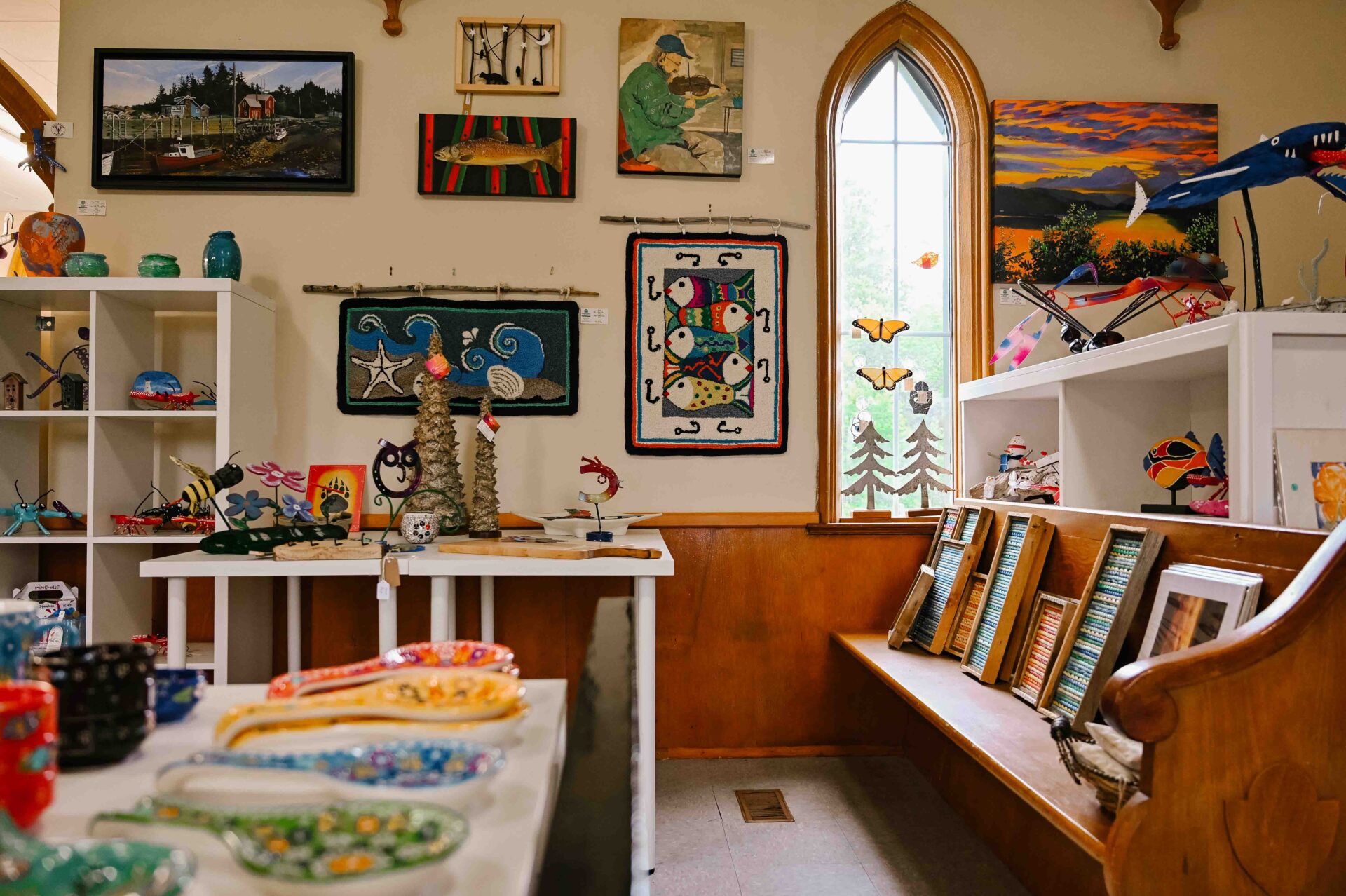 a variety of crafts and art being sold inside the eastern shores gallery
