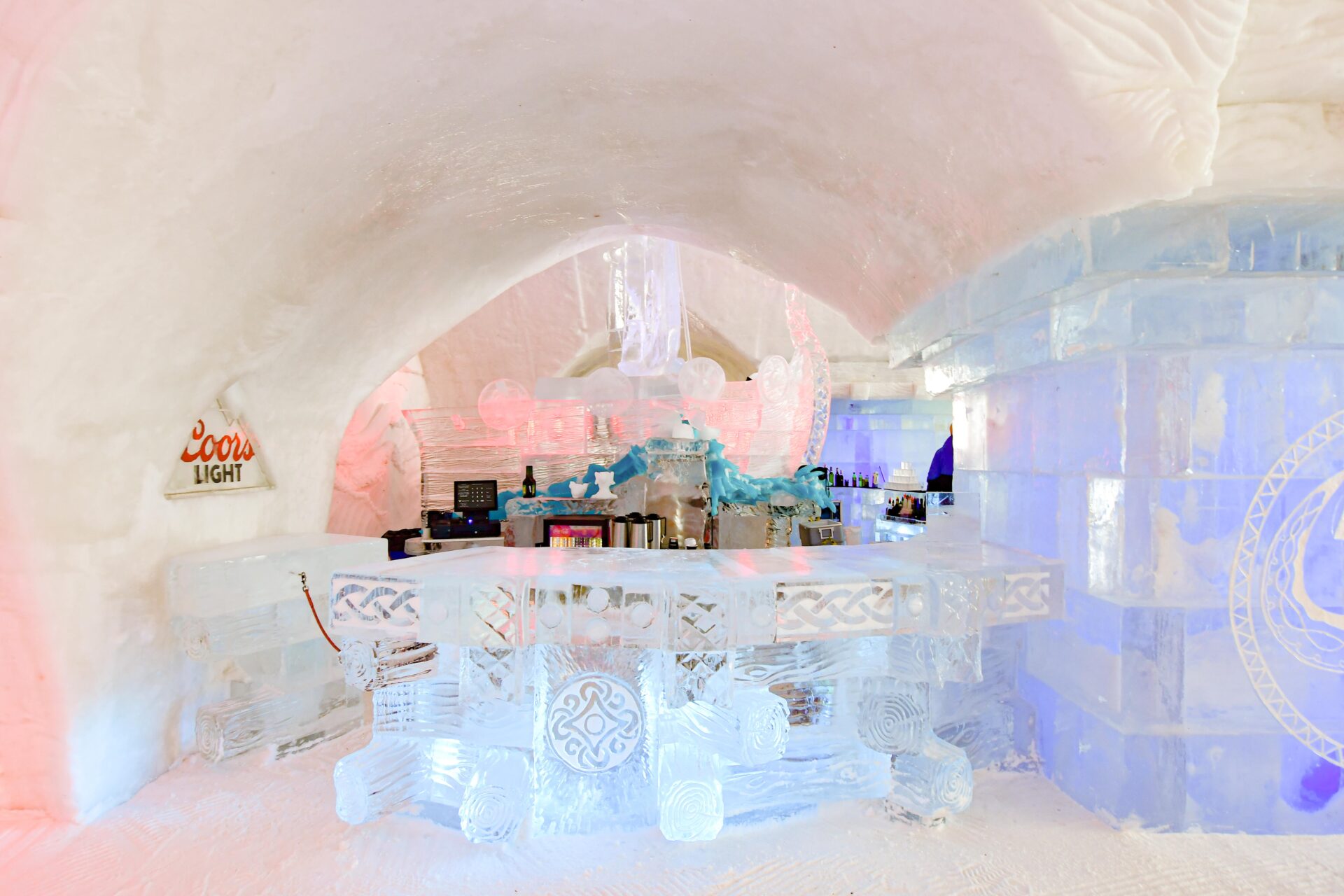 a detailed ice bar sculpture inside Hôtel de Glace