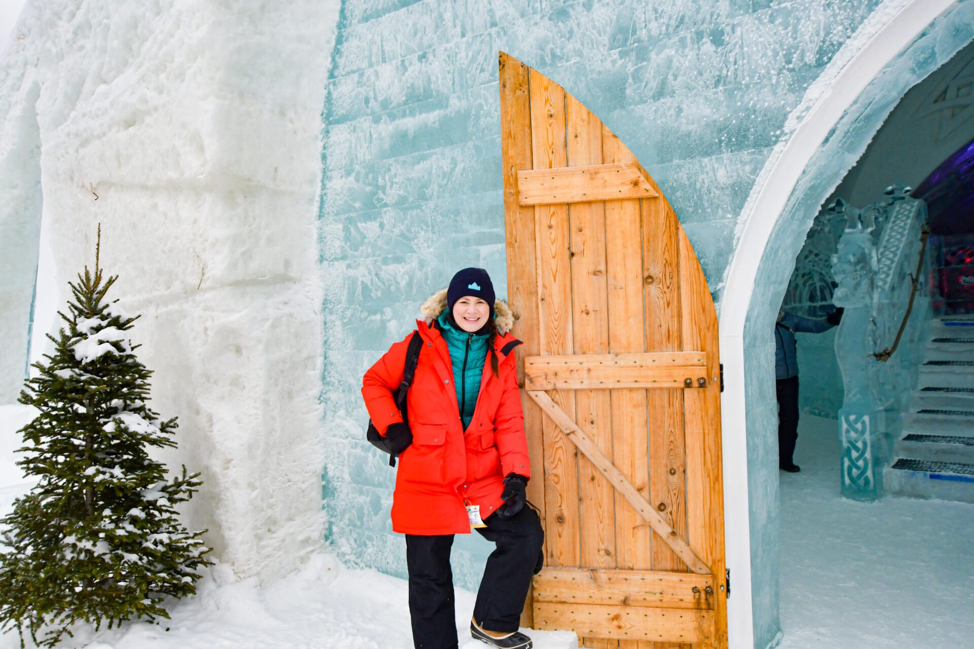 woman stands next to the open door at the Hôtel de Glace