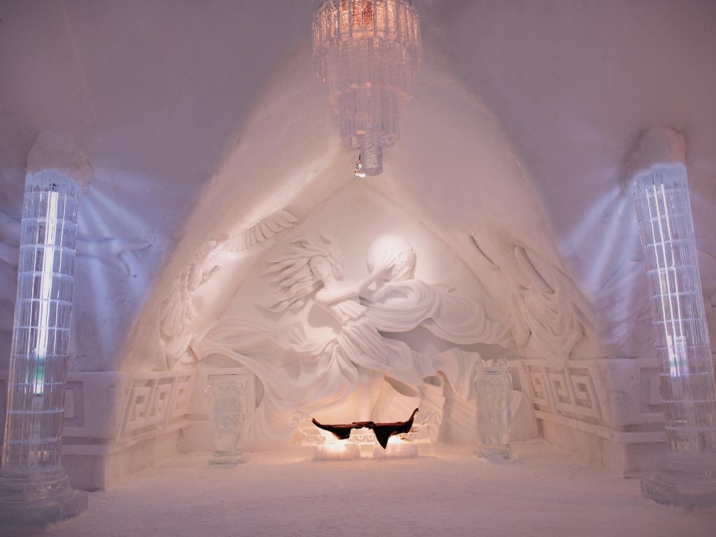 an elaborate snow sculpture on the wall of the great room at Hôtel de Glace 