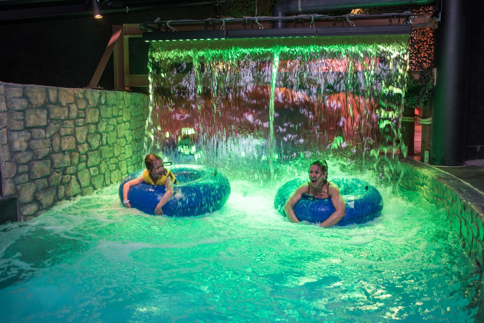 two people floating on tubes on a lazy river