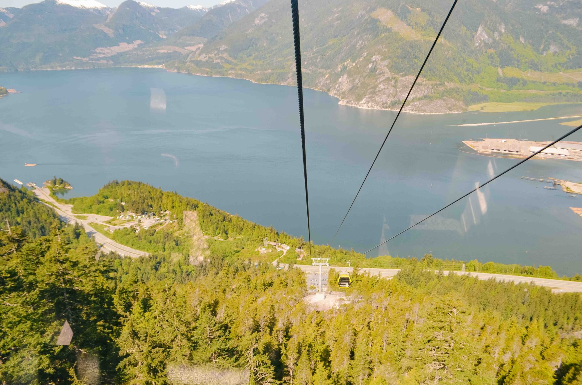 looking down the cables at the hiking trails and howe sound below the sea to sky gondola