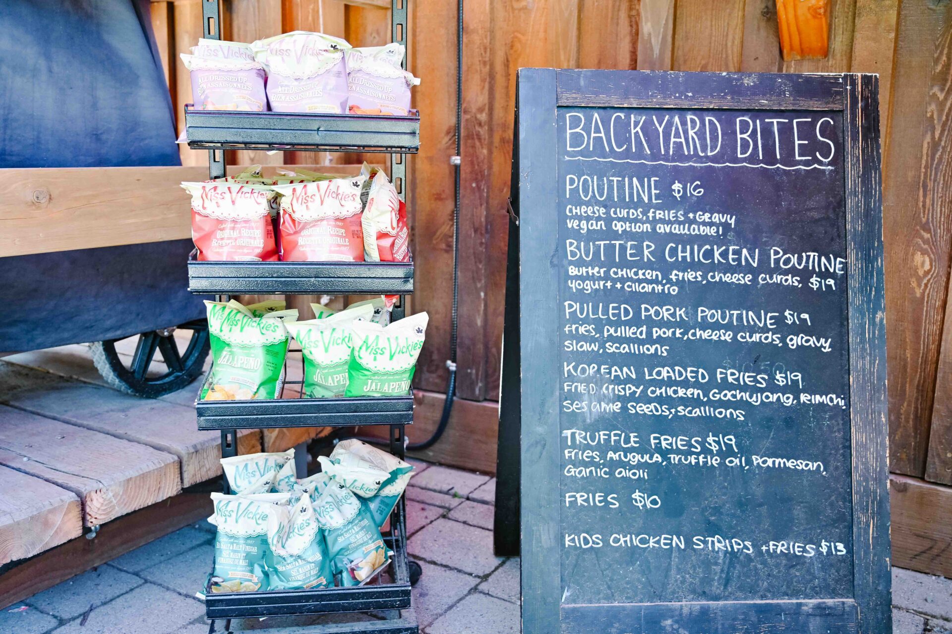 display of chips and a menu board outside the backyard bites food stand