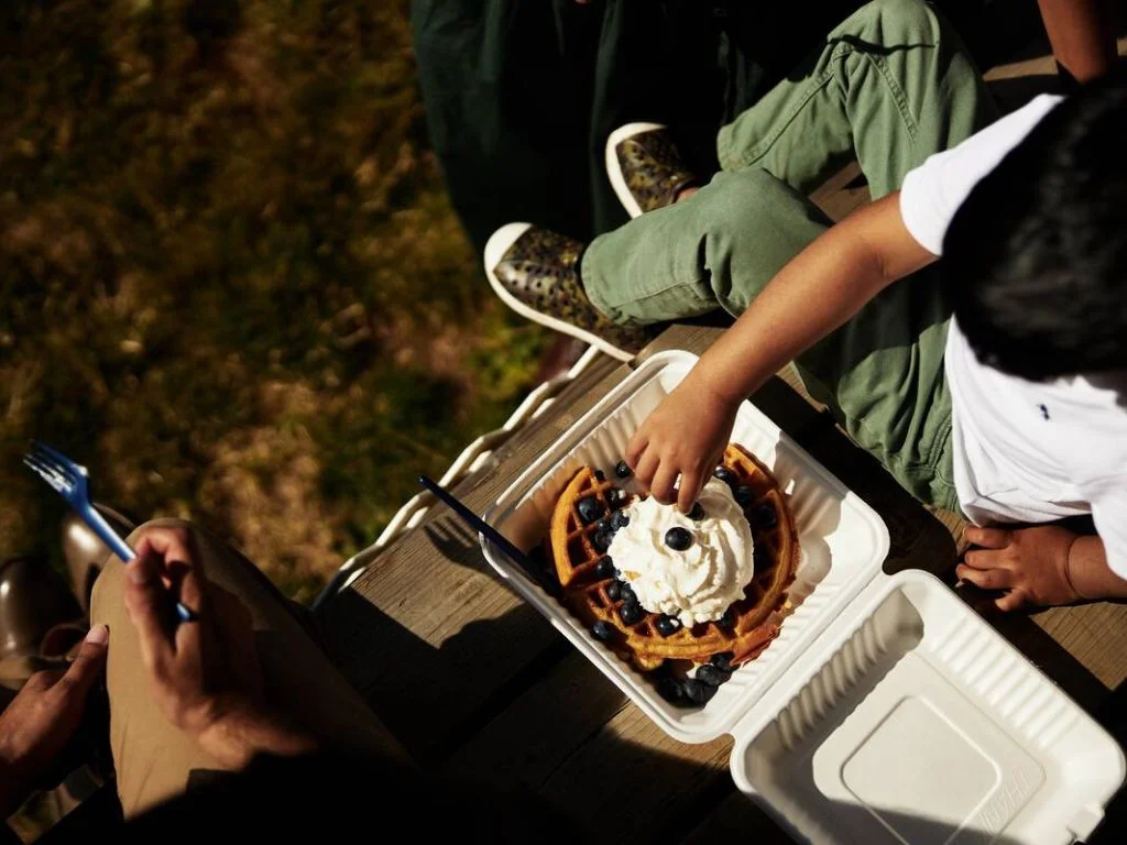two people enjoying a fruit covered waffle at krause berry farm