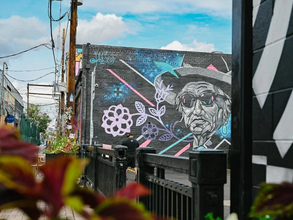 mural of an older man surrounded by a few flowers and stripes
