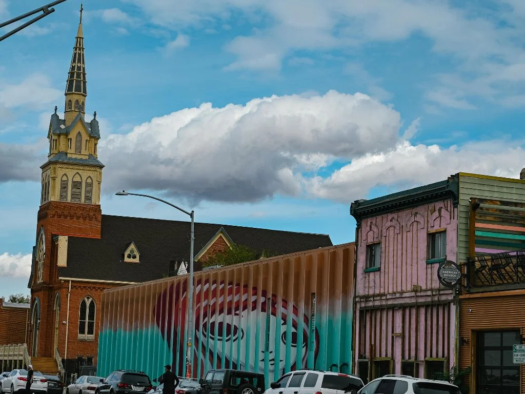 mural of a girl painted on the fins of a building, so when walking, it changes shape
