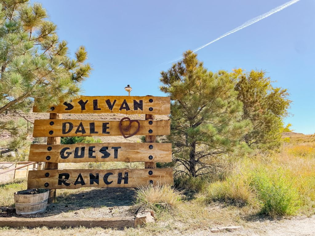 front entrance sign at sylvan dale guest ranch