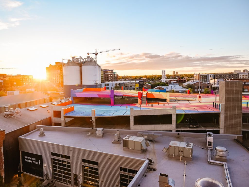 view of the large colourful mural, street art covered parking garage