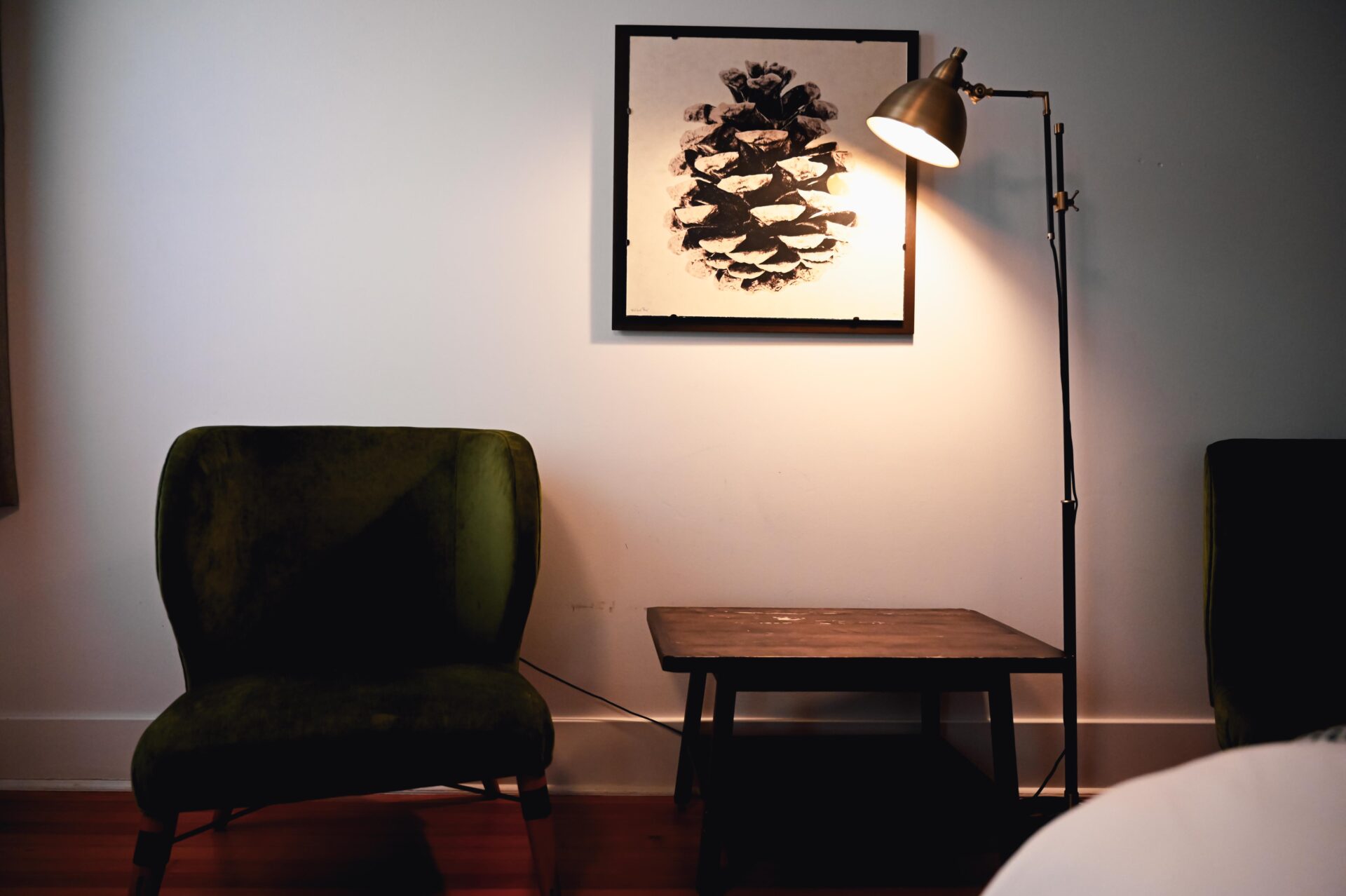 close up photo of a chair, table, lamp and pinecone art work inside a room at the armstrong hotel fort collins