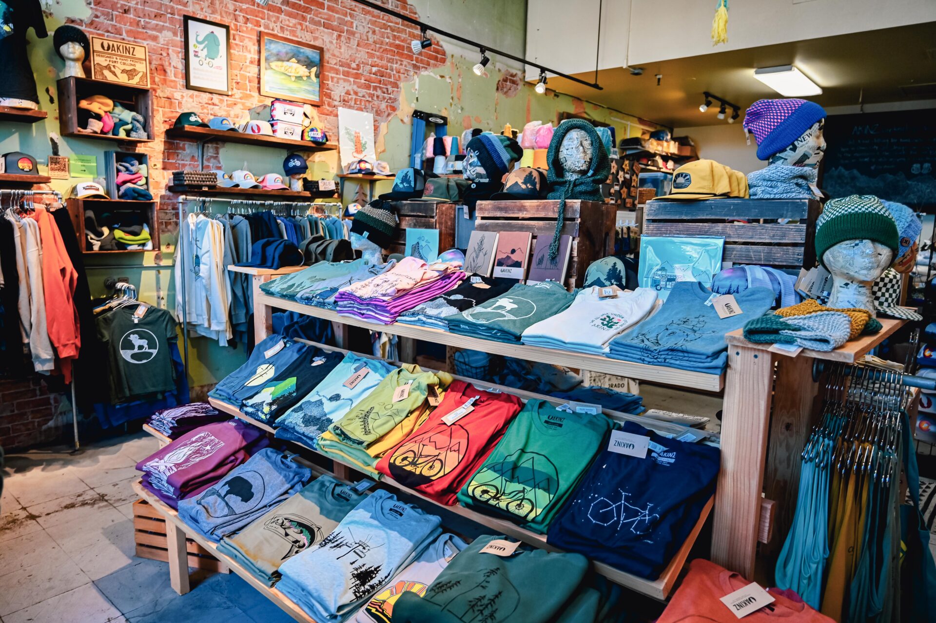 inside the Akinz store in fort collins, printed tshirts sit on a shelf display