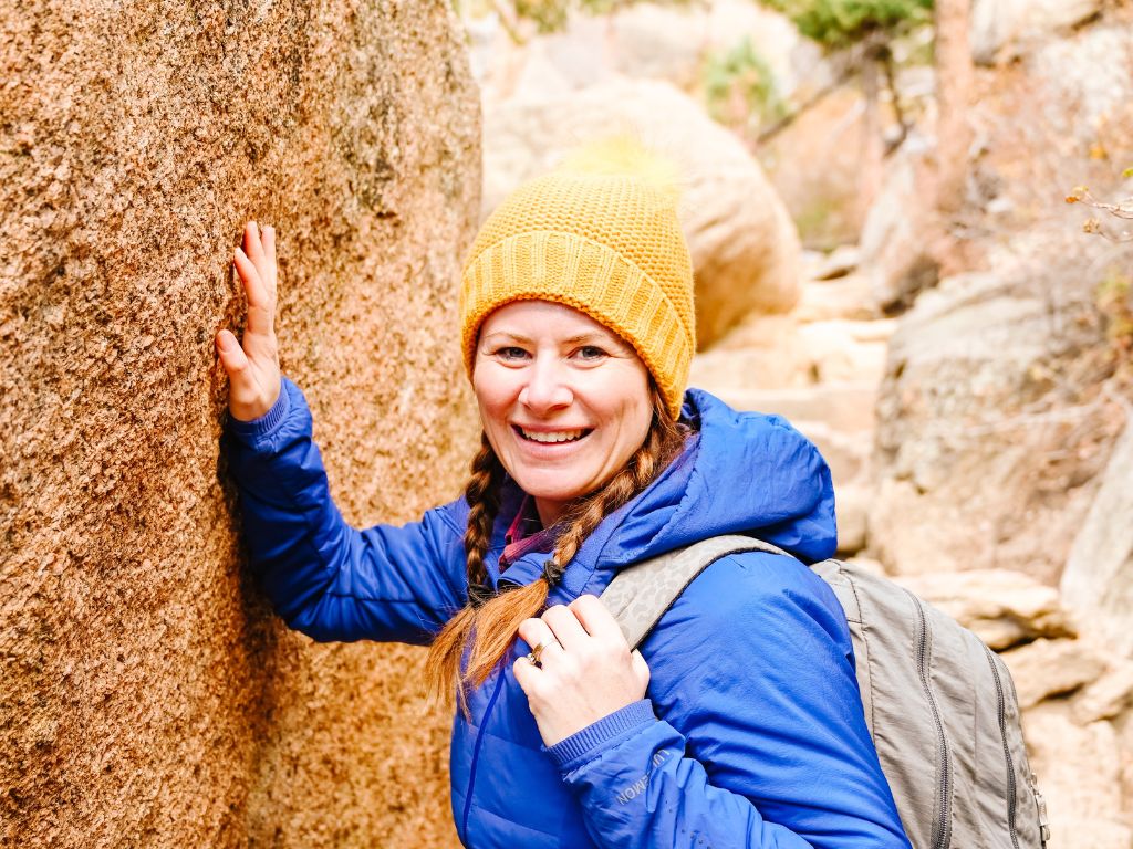 close up of a woman leaning against a rock on the gem lake hike