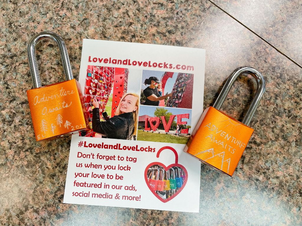 two orange locks engraved with adventure awaits in loveland colorado