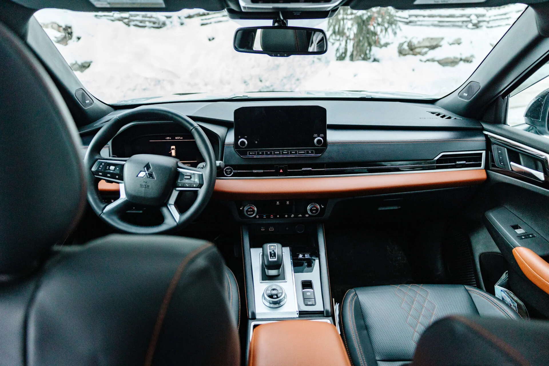 inside view of the front seats, dashboard and steering wheel of a mitsubishi outlander phev