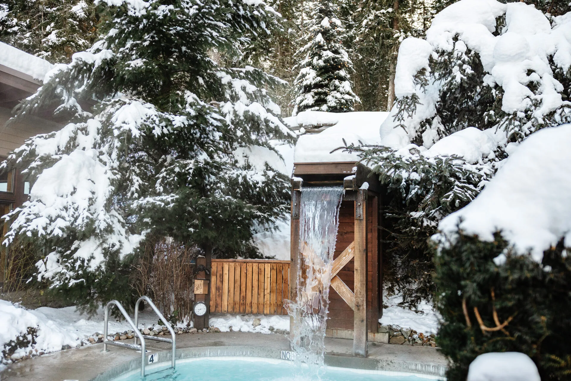 cold plunge waterfall and pool at the scandinave spa in whistler in winter
