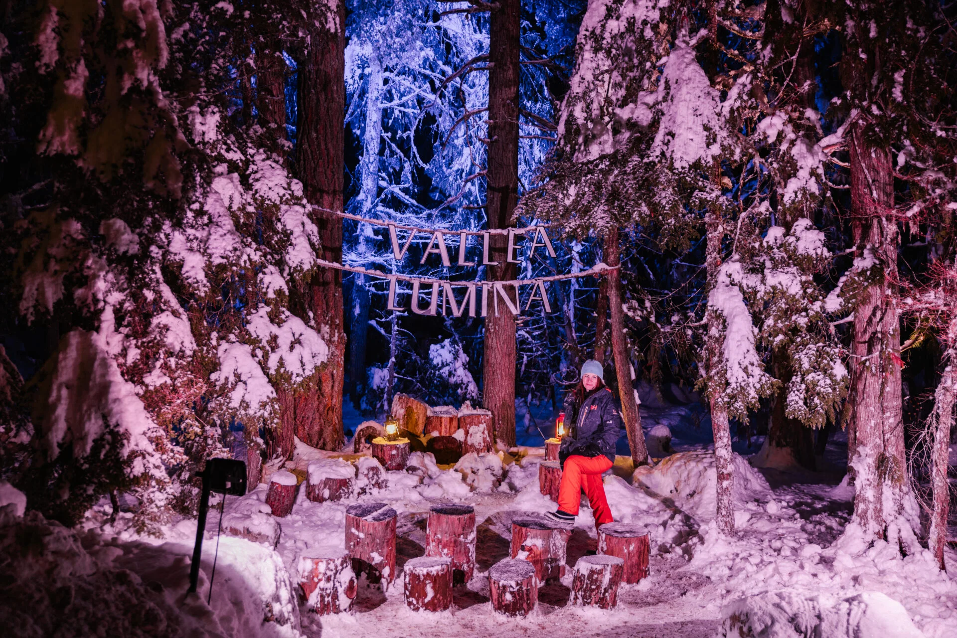 a woman stands in the forest at vallea lumina, one of the things to do in whistler in winter for non-skiers