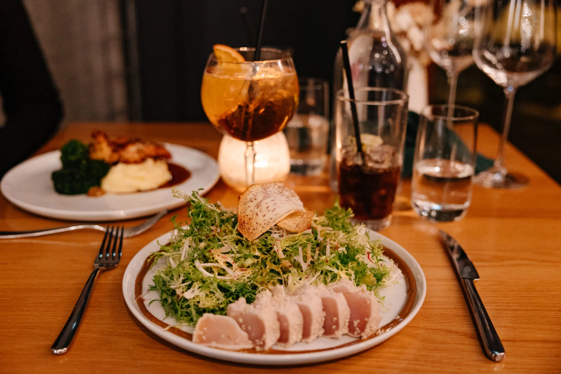 plates of food and drinks at the den restaurant at nita lake lodge in whistler