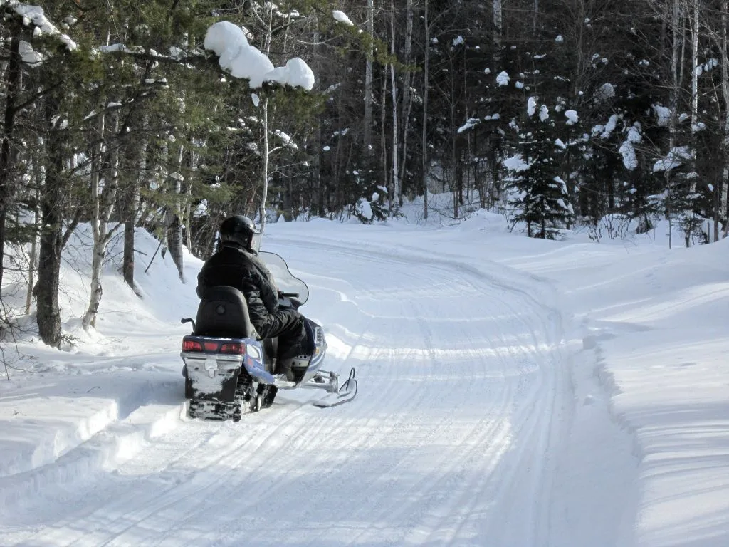 a person riding a snowmobile on a tour, one of the things to do in whistler in winter for non-skiers
