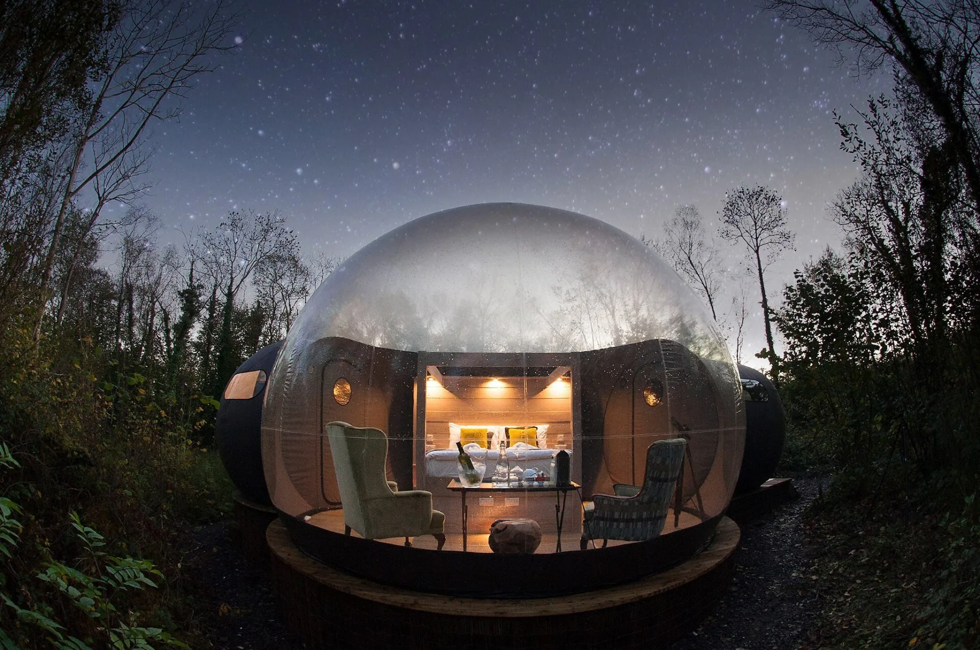 view from the outside of a Finn Lough bubble dome when its starting to get dark and the stars are coming out