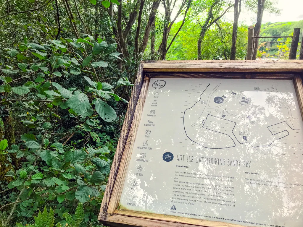 sign in the forest outlining the spa experience at finn lough resort