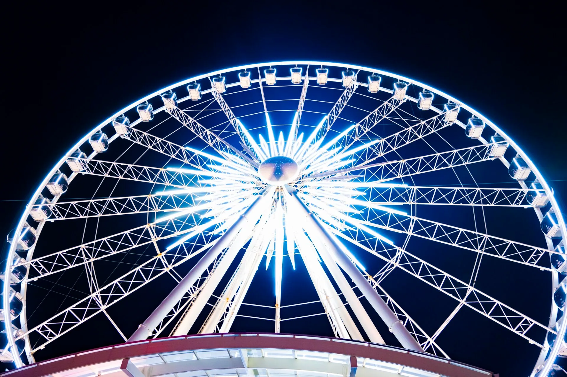 looking up at the niagara skywheel at night, it is lit up with bright white lights