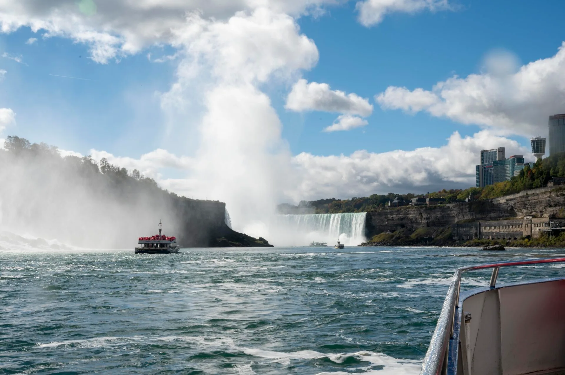 view from the front of a niagara city cruises boat as it sails towards the falls