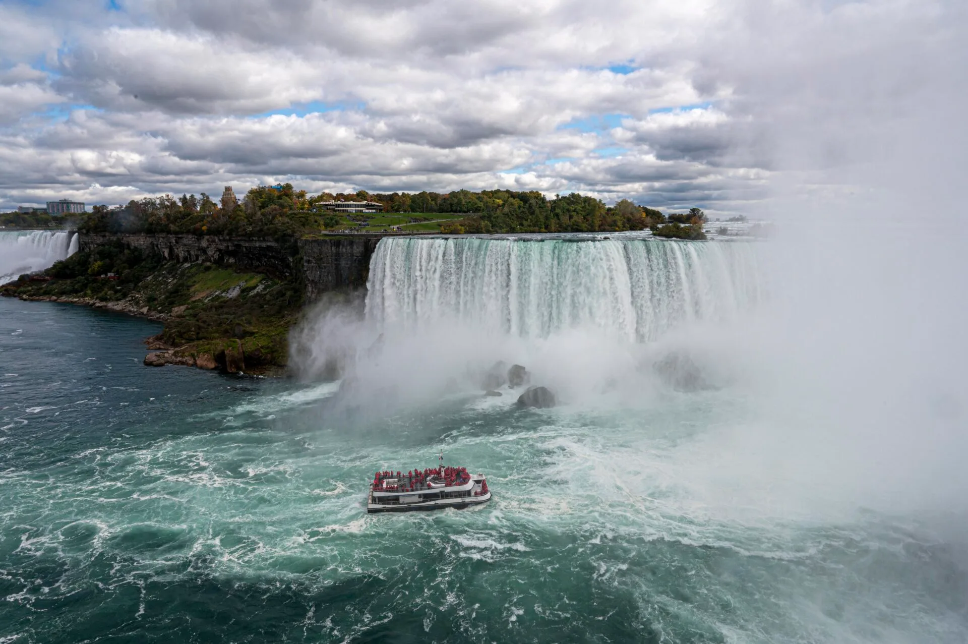 looking down at a niagara city cruises boat at it sails towards niagara falls