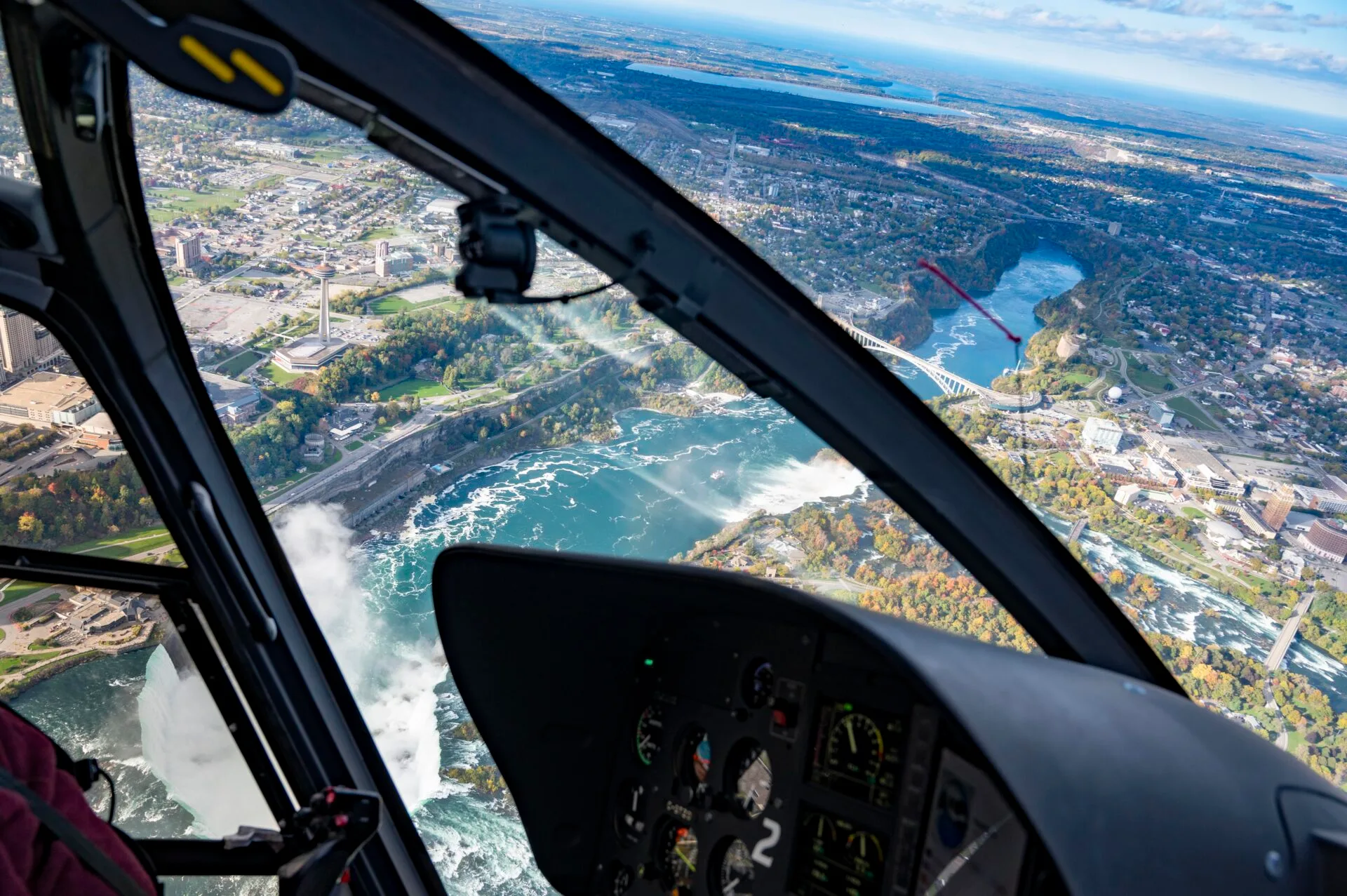 aerial view of niagara falls from a helicopter, the helicopter instrument panel can be seen