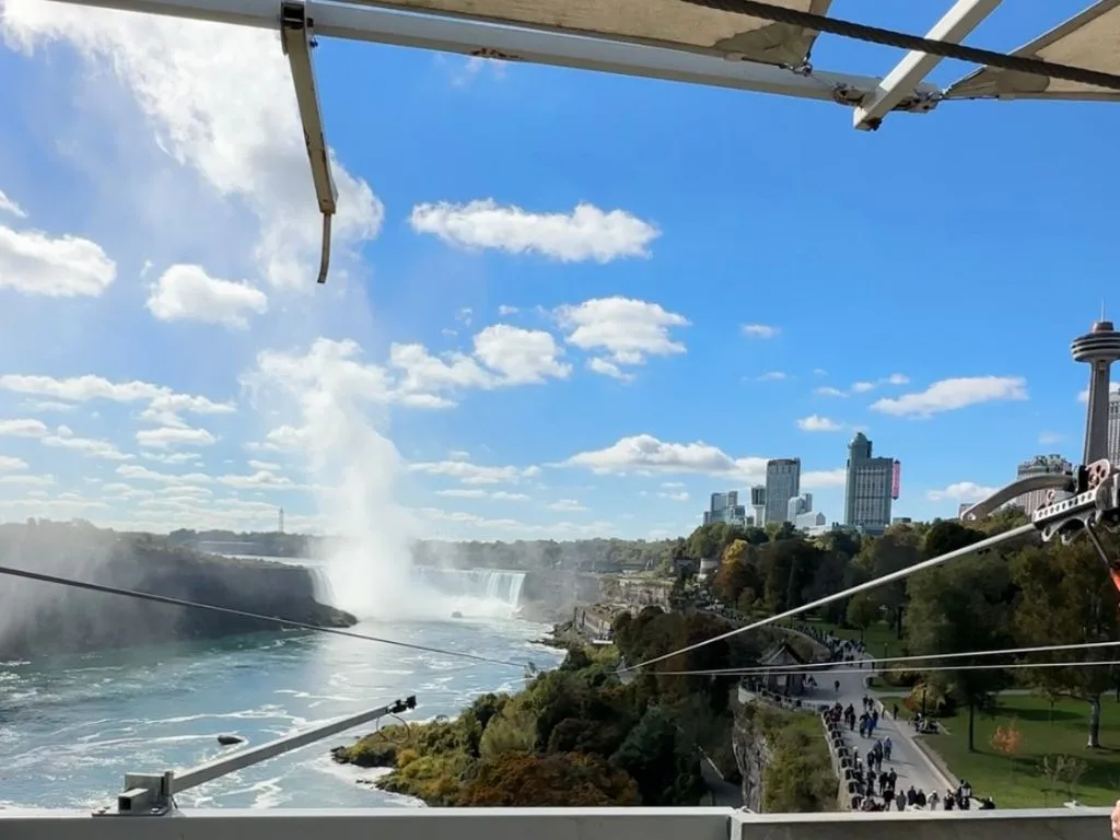 looking down at the ziplines form the top of the tower, niagara falls are in the background