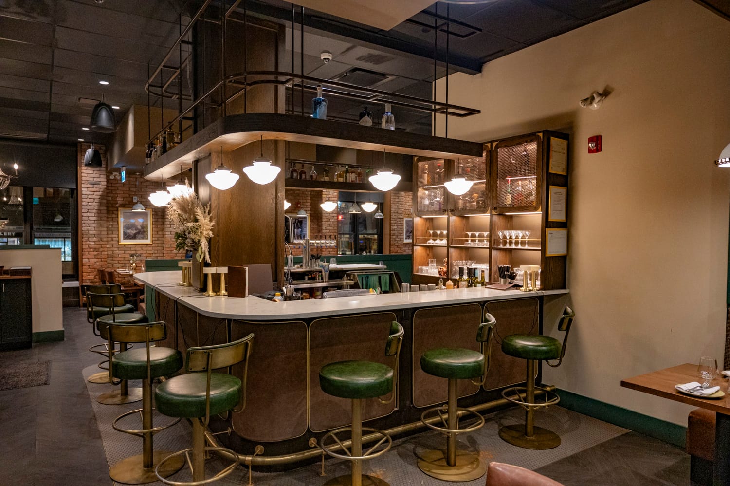bar area seating inside brazen restaurant in banff